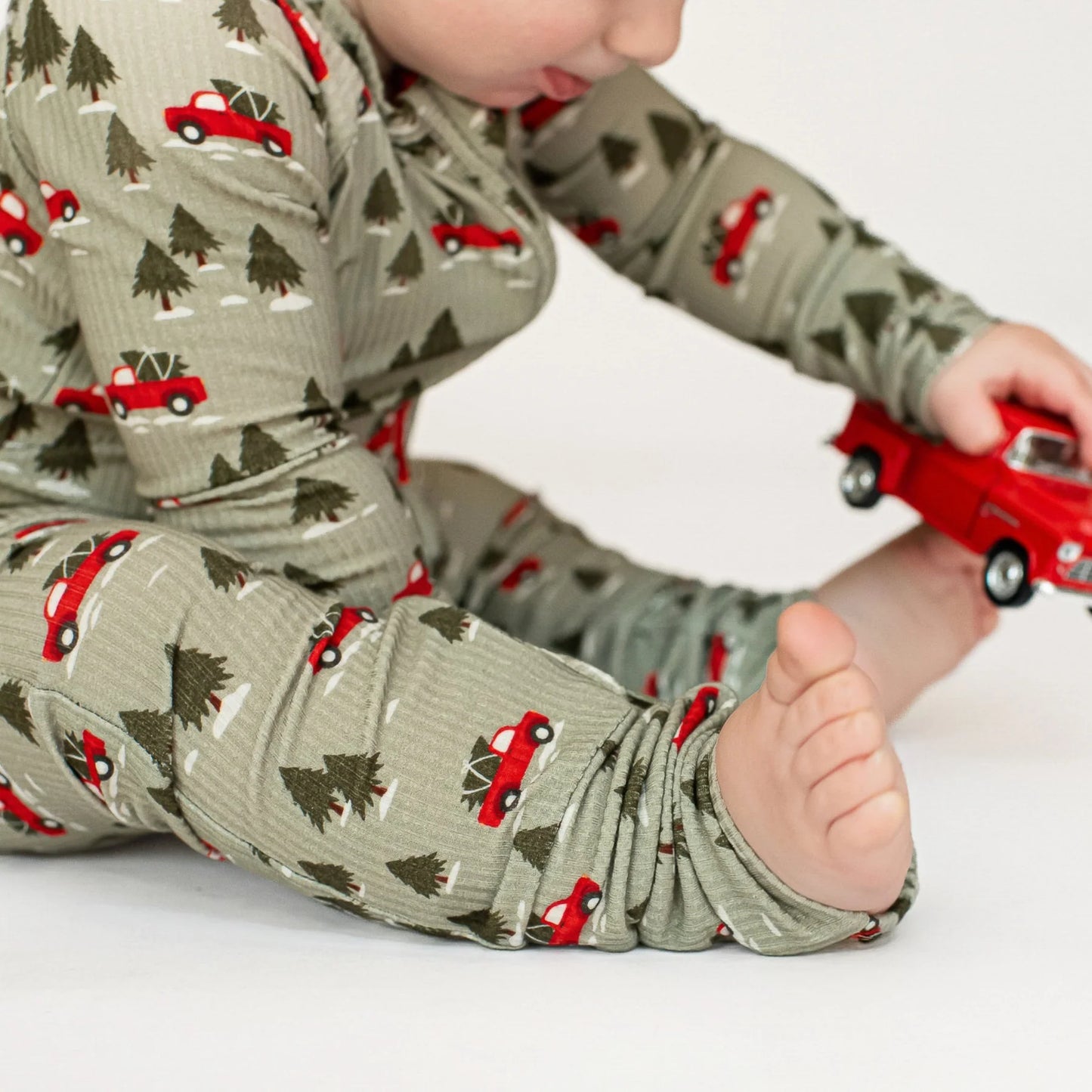 Bamboo Zip Sleeper w Fold-Over Feet | Red Christmas Trucks (Small Ribbed)