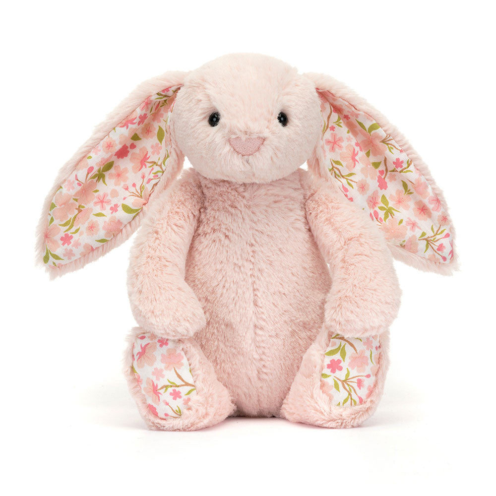 Floral-patterned pink bunny plush toy on a white background