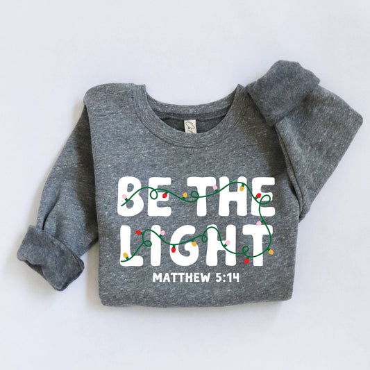 Gray sweatshirt with 'Be the Light' text and Christmas lights design